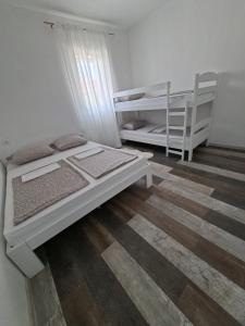 a bedroom with two beds and a bunk bed at Holiday Home with Private Pool in Blagaj +28 photos