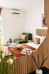 a large bed in a room with a couch at Apartments Katana in Ulcinj