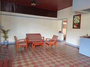 a room with chairs and a table and a couch at Hostal Calle Real in León