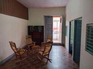 a room with chairs and a table and a door at Hostal Calle Real in León