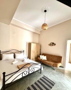a bedroom with a bed and a couch at Olea Central Stay in Nea Kallikrateia