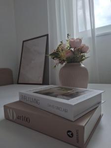 two books sitting on a table with a vase of flowers at Holiday Home with Private Pool in Blagaj
