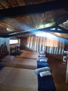 a group of four beds in a room at Dexa Hospedagem in Ouro Preto