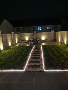 a garden at night with lights on the grass at The Boulevard in Dublin