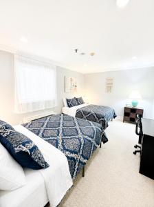 a bedroom with two beds and a desk at Gilford Beachfront Stay, Pool, WiFi & Parking Incl in Laconia +49 photos
