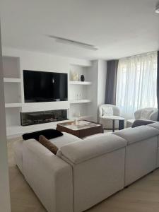 a living room with a couch and a flat screen tv at The Boulevard in Dublin