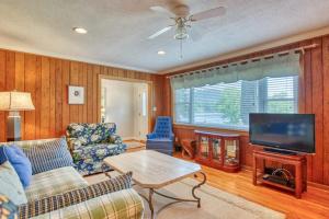 a living room with a couch and a tv at Cameron Lakeside in Lake Junaluska