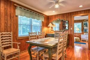 a dining room with a wooden table and chairs at Cameron Lakeside in Lake Junaluska +30 photos