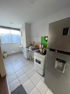 a kitchen with a refrigerator and a stove at Los Laureles -Executive Residence Departamento in Lima +13 photos