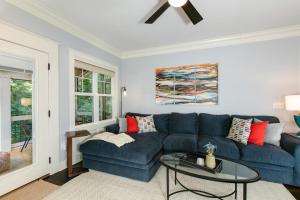 a blue couch in a living room with a ceiling fan at Blue Ridge Haven in Black Mountain