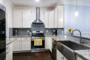 a kitchen with white cabinets and a stove top oven at Blue Ridge Haven in Black Mountain
