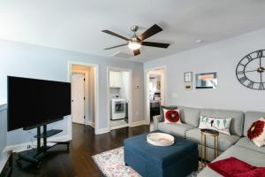 a living room with a couch and a flat screen tv at Blue Ridge Haven in Black Mountain +16 photos