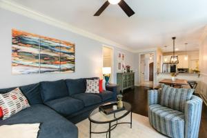 a living room with a blue couch and two chairs at Blue Ridge Haven in Black Mountain