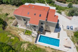 an aerial view of a house with a swimming pool at Apartment Harmonia in Dobrota
