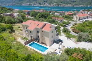an aerial view of a house with a swimming pool at Apartment Harmonia in Dobrota