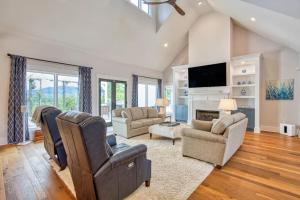 a living room with a couch chairs and a tv at Mountain Majesty in Mill Spring