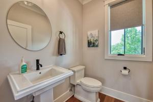 a bathroom with a sink and a toilet and a mirror at Mountain Majesty in Mill Spring