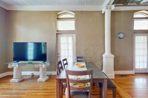 a dining room with a table and a tv at Mountain Stream Haven in Whittier
