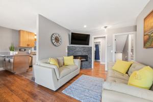a living room with a couch and a fireplace at Upper Lakeshore Living in Lake Junaluska