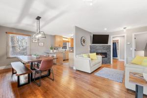 a living room with a table and a dining room at Upper Lakeshore Living in Lake Junaluska