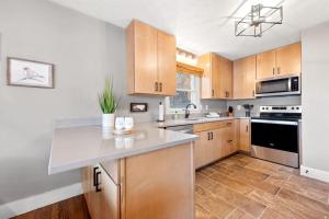 a kitchen with wooden cabinets and a white counter top at Upper Lakeshore Living in Lake Junaluska
