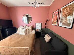 a bedroom with a bed and a couch at The Seabreeze Terrace Apartment in Turku