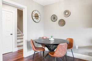 a dining room with a table and chairs and a clock at Lower Lakeshore Living in Lake Junaluska