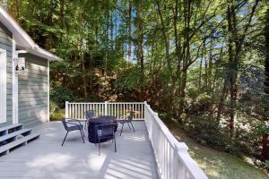 a porch with chairs and a table on a house at Cherry Tree Lodge in Black Mountain