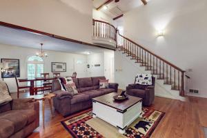 a living room with two couches and a staircase at Cherry Tree Lodge in Black Mountain