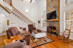 a living room with a fireplace and a tv at Cherry Tree Lodge in Black Mountain