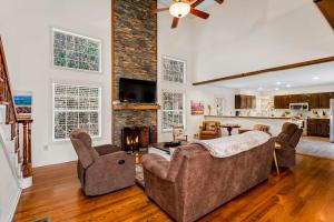 a living room with a couch and a fireplace at Cherry Tree Lodge in Black Mountain