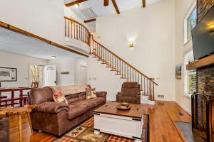 a living room with a couch and a fireplace at Cherry Tree Lodge in Black Mountain +24 photos