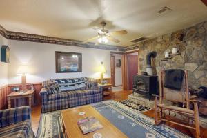 a living room with a couch and a stone fireplace at Humming Bird Crossing in Scaly Mountain