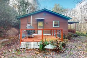 a red tiny house with a large porch at Humming Bird Crossing in Scaly Mountain