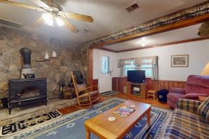 a living room with a couch and a fireplace at Humming Bird Crossing in Scaly Mountain