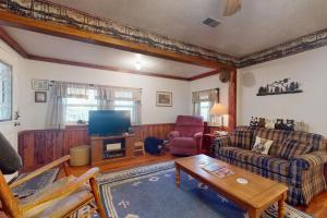 a living room with a couch and a tv at Humming Bird Crossing in Scaly Mountain +17 photos