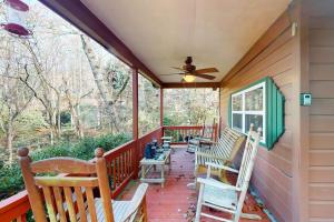 a porch with rocking chairs and a ceiling fan at Humming Bird Crossing in Scaly Mountain