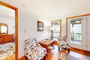 a living room with two chairs and a table at Raven's Respite in Saluda