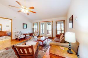 a living room with a couch and a ceiling fan at Raven's Respite in Saluda