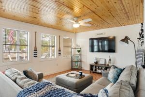 a living room with a couch and a flat screen tv at LT04FLR Torchbearer - Lower in Little Torch Key