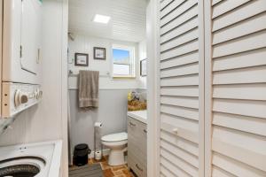 a white bathroom with a toilet and a sink at LT04FLR Torchbearer - Lower in Little Torch Key +19 photos