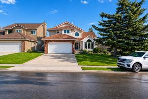 a white car parked in front of a house at Metta Stays Edgemont in Calgary