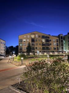 a large building with lights in front of a street at The Seabreeze Terrace Apartment in Turku