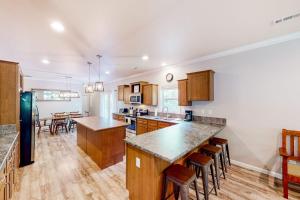 a kitchen with wooden cabinets and a counter top at Hilltop Hideaway in Asheville