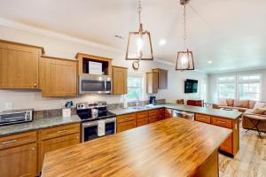 a kitchen with wooden cabinets and a wooden counter top at Hilltop Hideaway in Asheville +27 photos