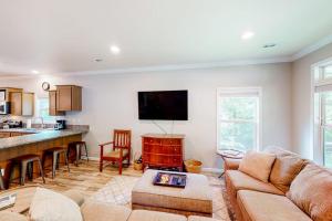 a living room with a couch and a kitchen at Hilltop Hideaway in Asheville