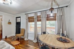 a dining room with a wooden table and chairs at Meet Me At The Creek in Whittier