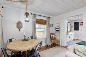 a living room with a wooden table and chairs at Meet Me At The Creek in Whittier