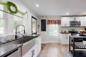 a white kitchen with a sink and a counter top at Meet Me At The Creek in Whittier