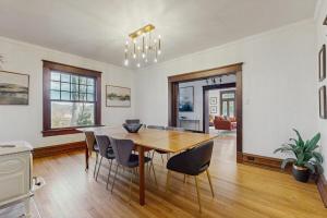 a dining room with a wooden table and chairs at Love Lane Tudor in Waynesville